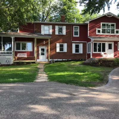 a large brick building with grass in front of a house