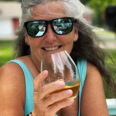 a woman wearing sunglasses talking on a cell phone