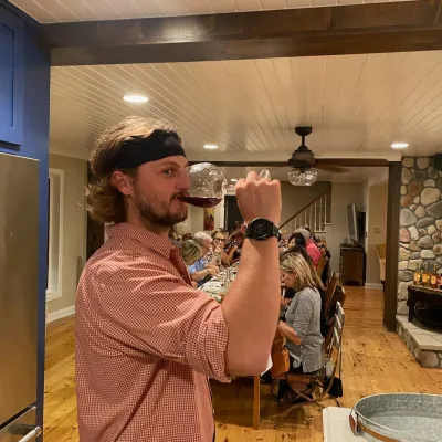a man holding a phone and standing in a room