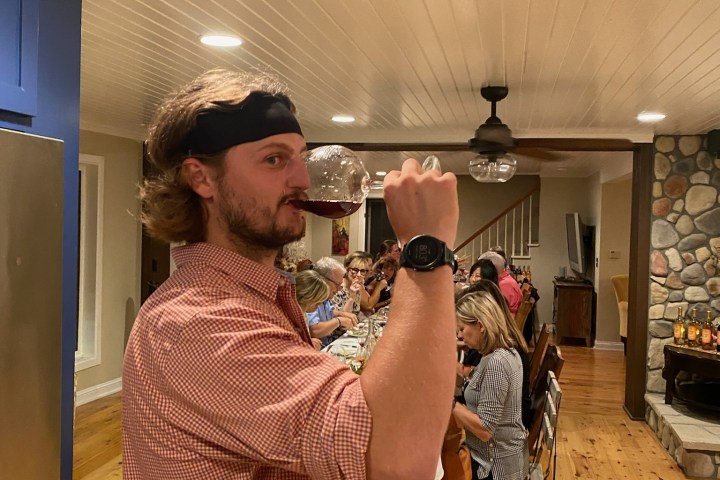 a man holding a phone and standing in a room