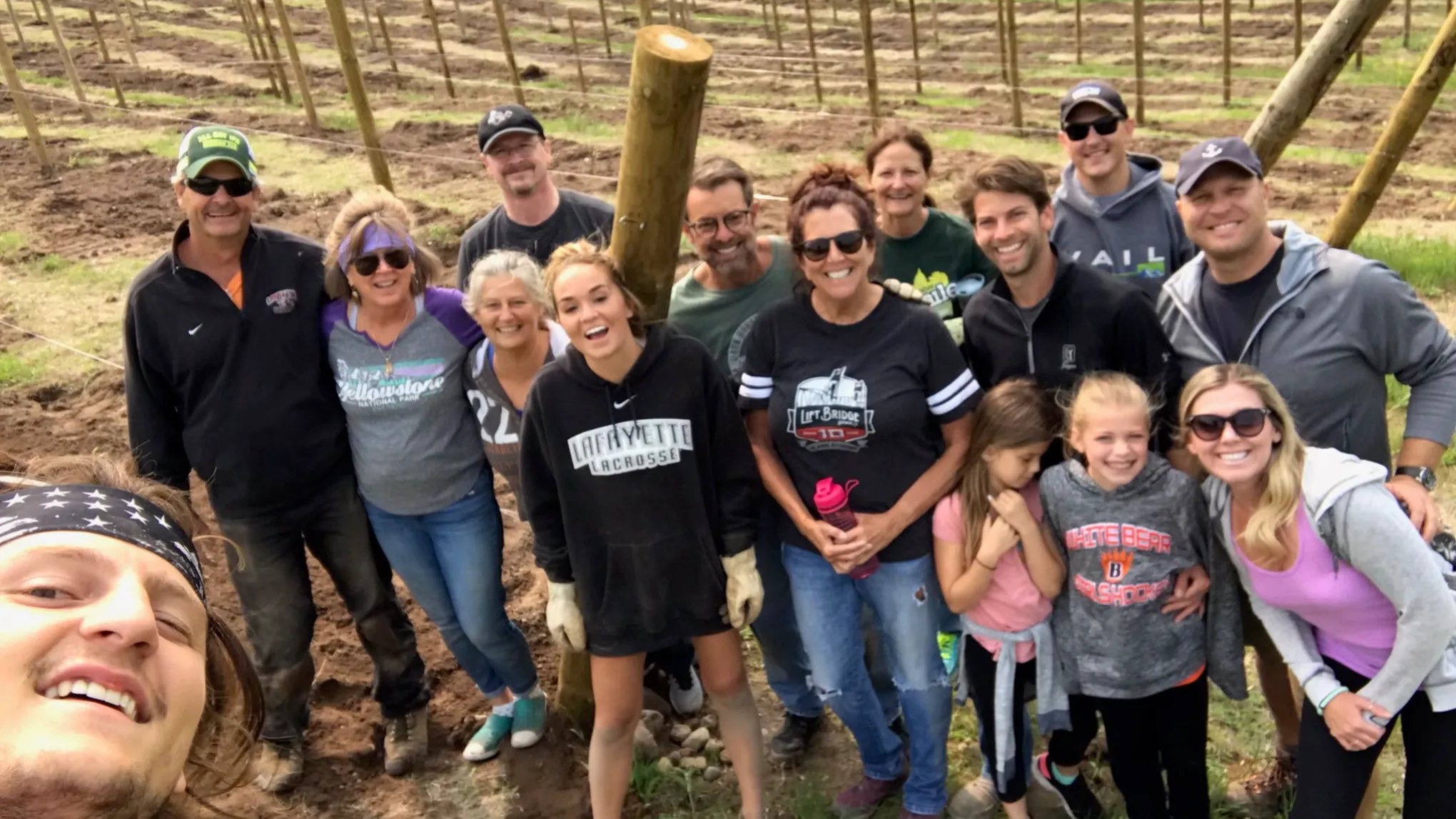 Heather Rayle et al. standing in front of a crowd posing for the camera