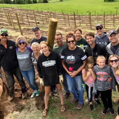 Heather Rayle et al. standing in front of a crowd posing for the camera