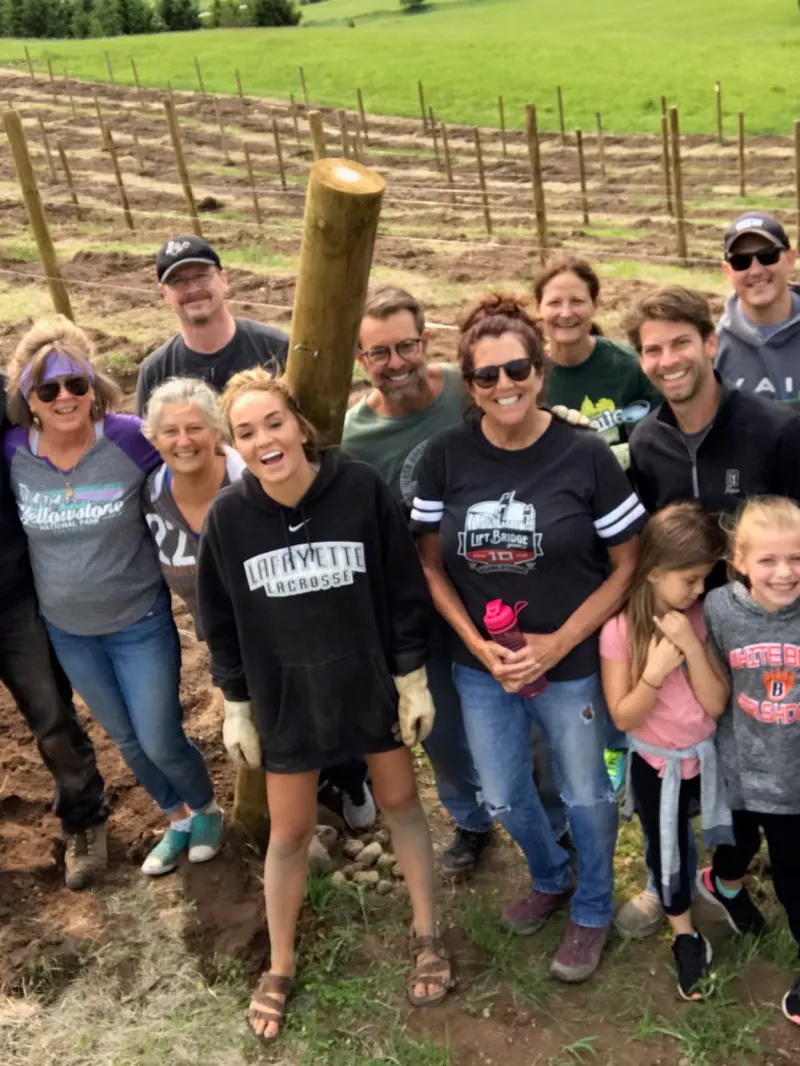 Heather Rayle et al. standing in front of a crowd posing for the camera