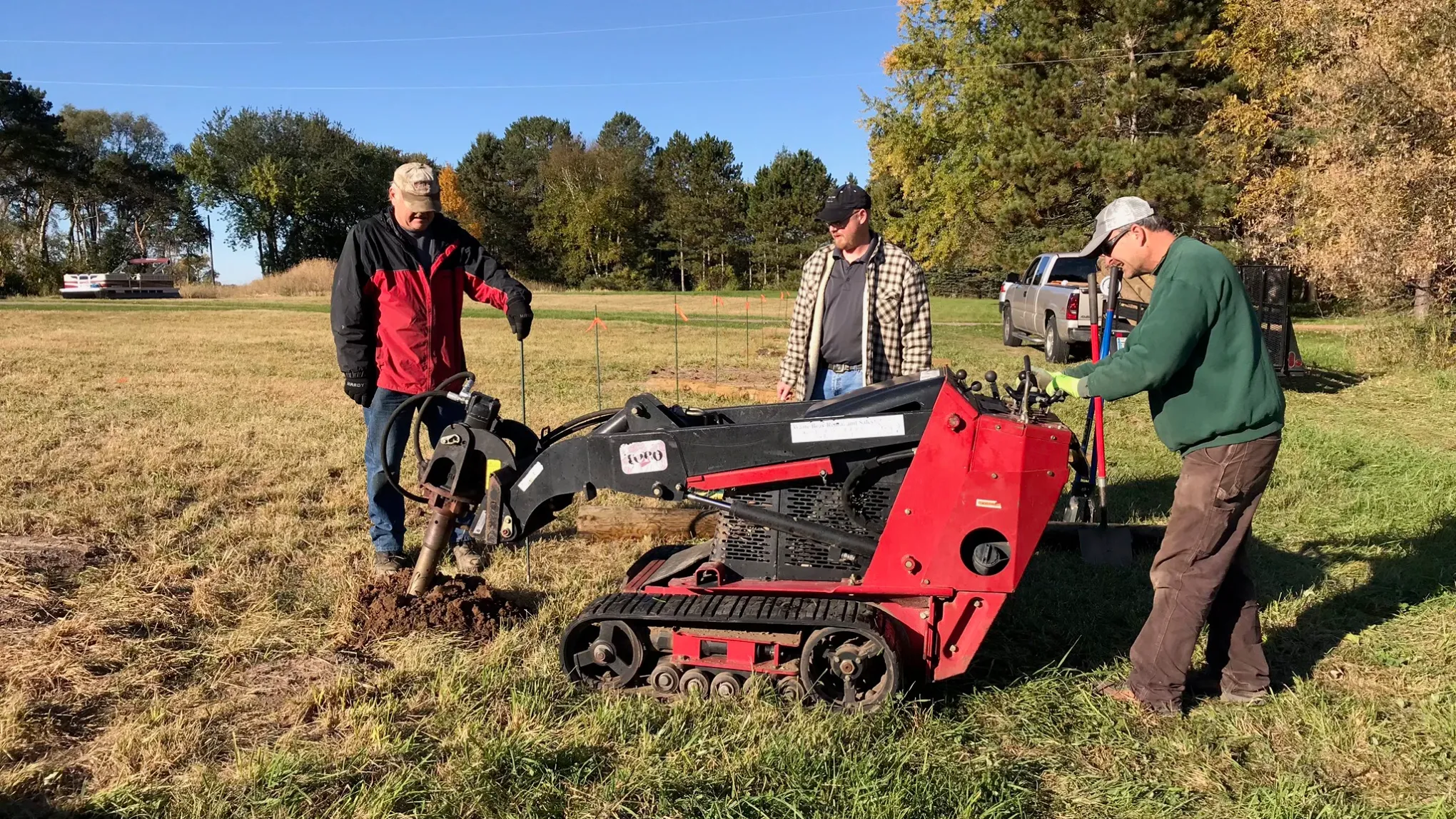 a group of people standing next to a tractor
