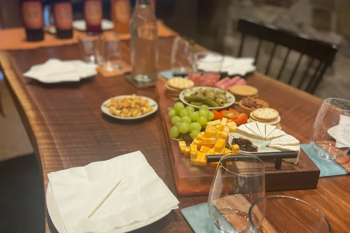 a wooden table topped with plates of food