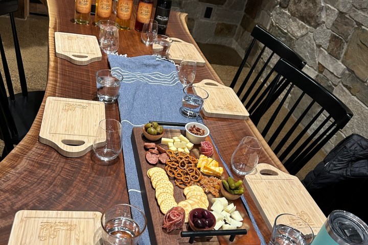 a wooden cutting board with a cake on a table